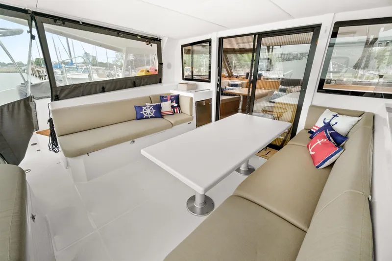Slide: The Image of Spacious interior of 2022 Nautitech 40 Open catamaran with comfortable seating and nautical-themed cushions. - 16
