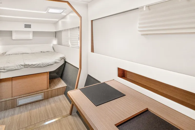 Slide: The Image of Modern interior of 2022 Nautitech 40 Open catamaran with cozy bed and wooden accents. - 22
