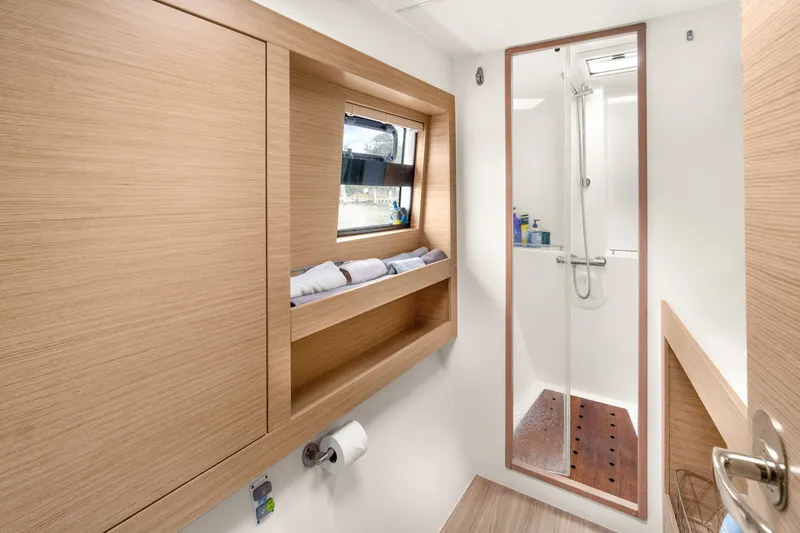 Slide: The Image of Modern bathroom interior of 2022 Nautitech 40 Open catamaran with shower and wooden accents. - 23