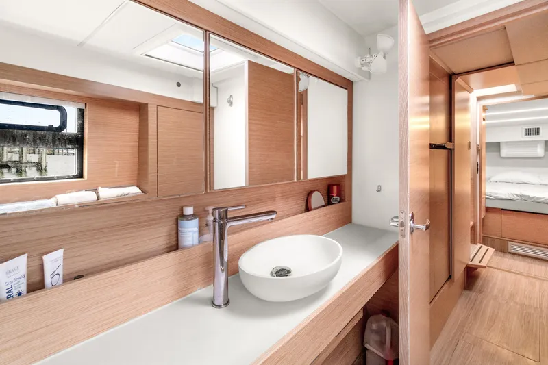 Slide: The Image of Modern bathroom interior on 2022 Nautitech 40 Open catamaran, featuring sleek design and wood accents. - 26