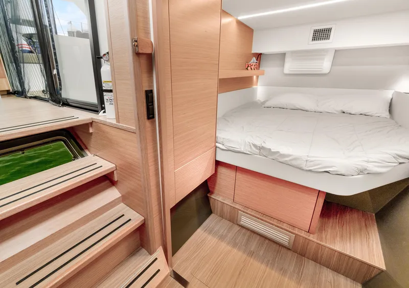 Slide: The Image of Interior of 2022 Nautitech 40 Open catamaran, featuring a cozy cabin with a double bed. - 27