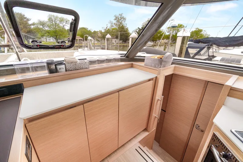 Slide: The Image of Modern interior of 2022 Nautitech 40 Open yacht with sleek cabinetry and large windows. - 28
