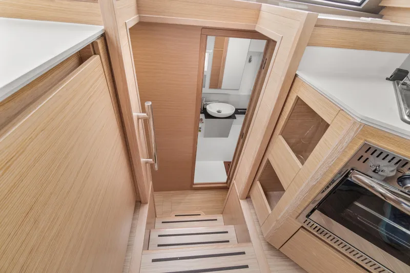 Slide: The Image of Interior of 2022 Nautitech 40 Open yacht, featuring modern kitchen and wooden staircase. - 33