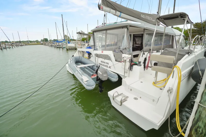 Slide: The Image of 2022 Nautitech 40 Open catamaran docked with inflatable dinghy attached. - 4
