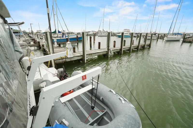 Slide: The Image of Nautitech 40 Open 2022 docked at marina with inflatable boat. - 43