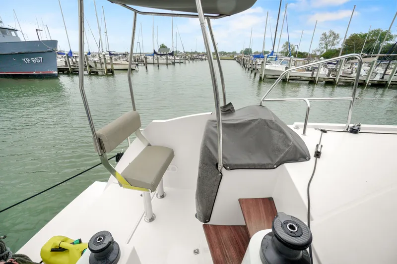 Slide: The Image of Nautitech 40 Open 2022 catamaran docked at marina, featuring helm and seating area. - 45