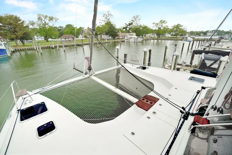 Slide: The Image of Nautitech 40 Open 2022 catamaran docked, featuring spacious deck and netting area. - 48