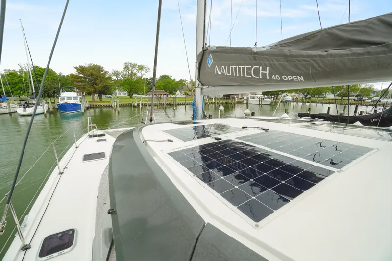 Slide: The Image of Nautitech 40 Open 2022 catamaran with solar panels docked in a marina. - 6