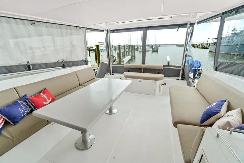 Slide: The Image of Interior of 2022 Nautitech 40 Open catamaran with seating and nautical-themed cushions. - 9