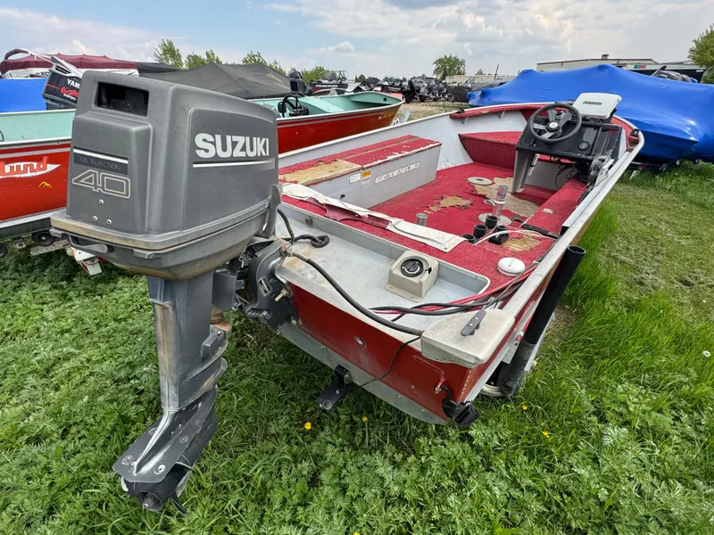 Slide: The Image of 1994 Alumacraft SC boat with Suzuki 40 outboard motor on grassy field. - 3