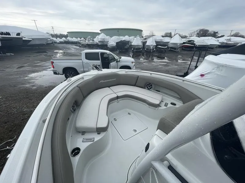 Slide: The Image of 2023 Finseeker 210 FS.2 boat with spacious seating, parked near a white truck. - 11