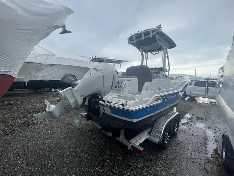 Slide: The Image of 2023 Finseeker 210 FS.2 boat on trailer, parked outdoors, overcast sky. - 5
