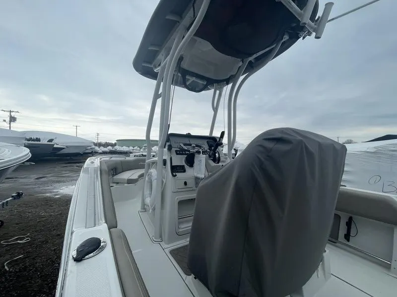 Slide: The Image of 2023 Finseeker 210 FS.2 boat with covered console and seating, docked outdoors. - 7