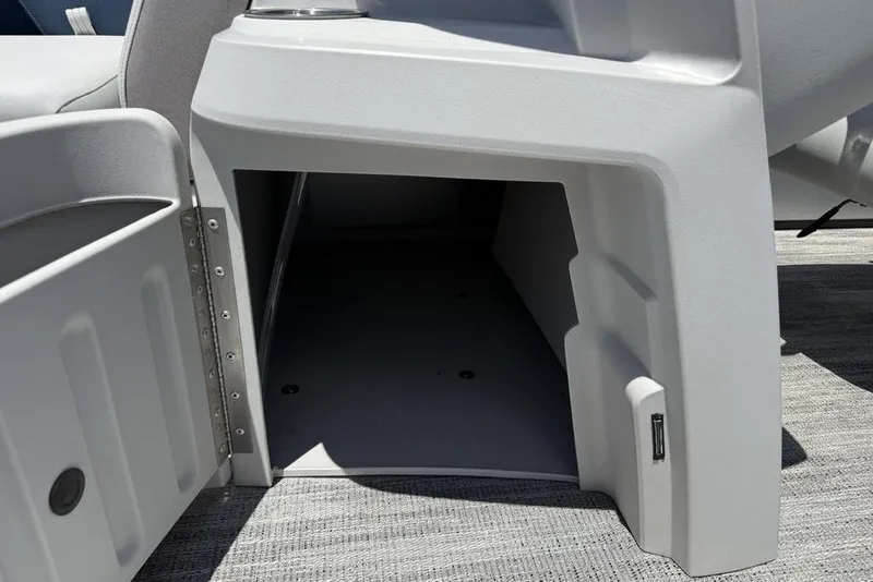 Slide: The Image of Open storage compartment on 2025 Godfrey Sweetwater 2286 SB boat, showcasing interior space. - 11