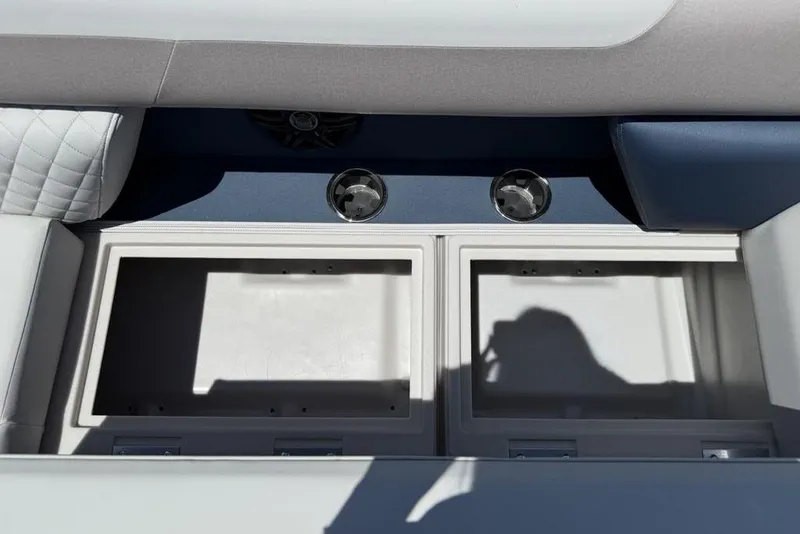 Slide: The Image of Interior storage compartments of 2025 Godfrey Sweetwater 2286 SB boat, featuring dual cup holders. - 13