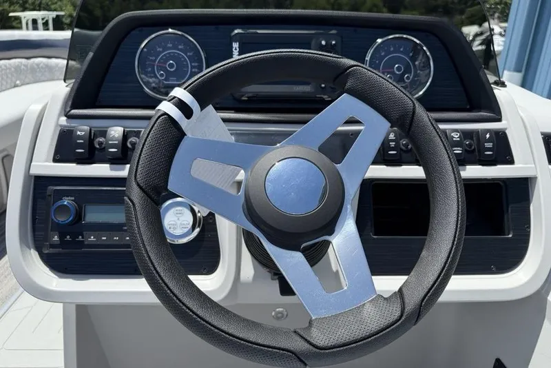 Slide: The Image of Steering wheel of 2025 Godfrey Sweetwater 2286 SB boat, featuring modern dashboard controls. - 14