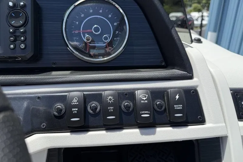 Slide: The Image of Control panel of 2025 Godfrey Sweetwater 2286 SB boat with switches and gauge. - 18