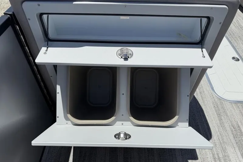 Slide: The Image of Storage compartments on 2025 Godfrey Sweetwater 2286 SB boat, featuring dual bins. - 21