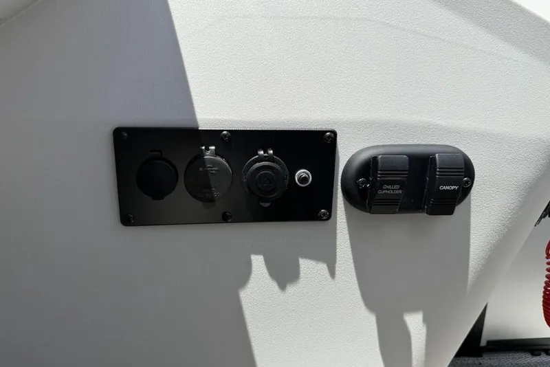 Slide: The Image of Control panel on 2025 Godfrey Sweetwater 2286 SB boat, featuring switches and outlets. - 22
