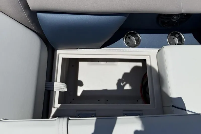 Slide: The Image of Open storage compartment on 2025 Godfrey Sweetwater 2286 SB boat, featuring sleek seating design. - 24