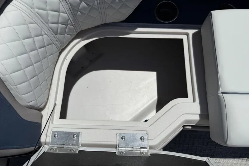 Slide: The Image of Open storage compartment on 2025 Godfrey Sweetwater 2286 SB boat with quilted seating. - 33