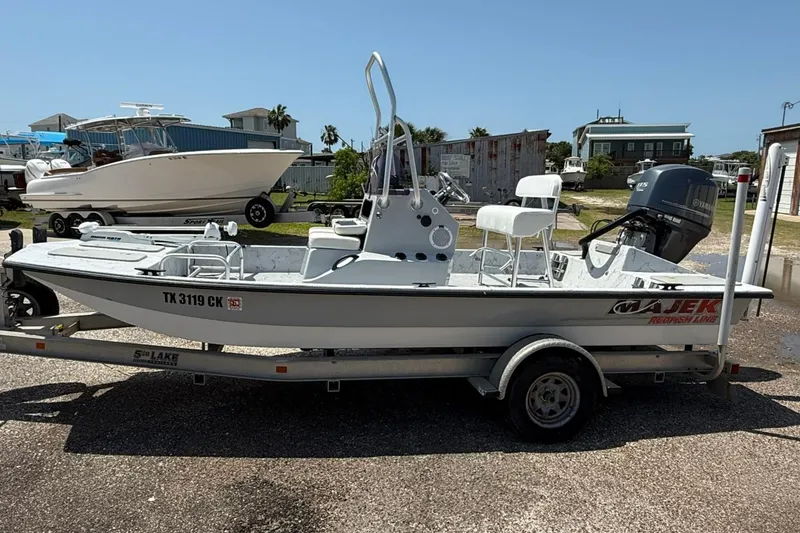 Slide: The Image of 2014 Majek 18 Redfish boat on trailer, parked outdoors. - 1