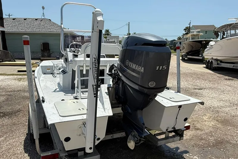 Slide: The Image of 2014 Majek 18 Redfish boat with Yamaha 115 engine, parked outdoors. - 3