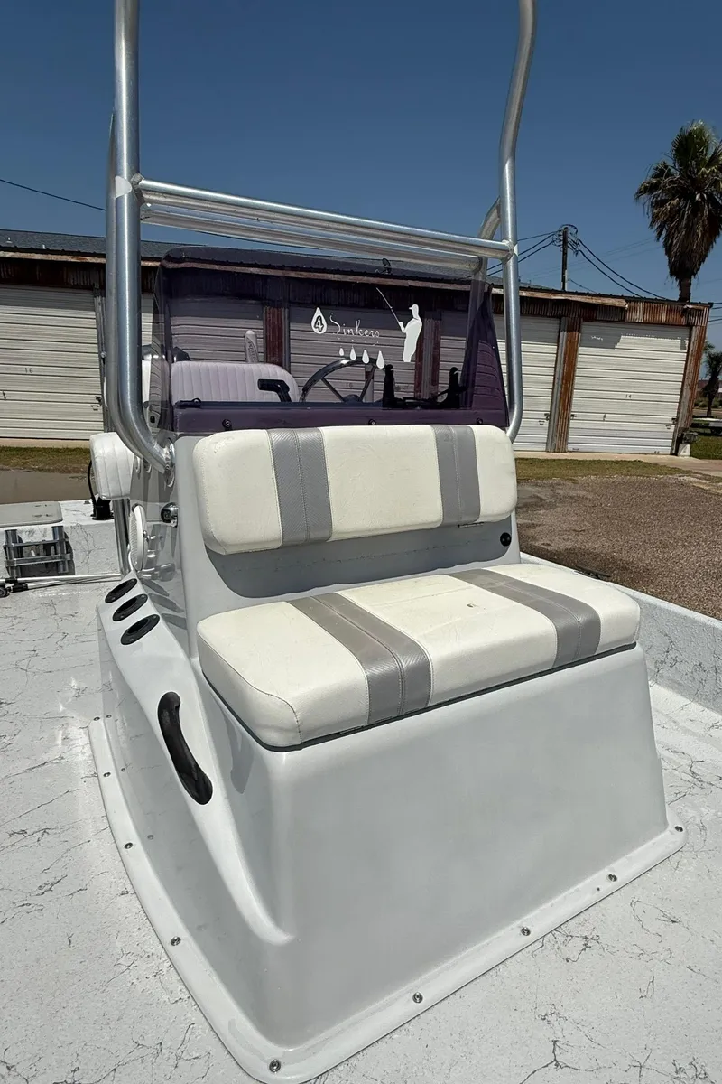 Slide: The Image of 2014 Majek 18 Redfish boat with cushioned seating and steering console. - 6
