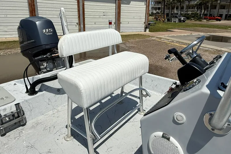 Slide: The Image of 2014 Majek 18 Redfish boat interior with white seating and Yamaha 115 outboard motor. - 7