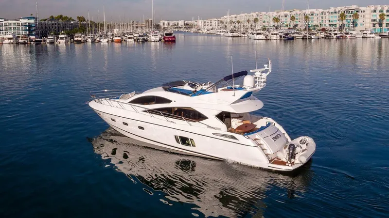 Slide: The Image of Luxury Sunseeker Manhattan 60 yacht, 2010 model, cruising in a serene marina setting. - 1