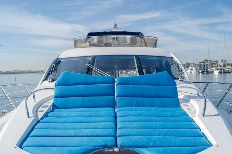 Slide: The Image of Sunseeker Manhattan 60 yacht with blue sun loungers, 2010 model, docked in a marina. - 10