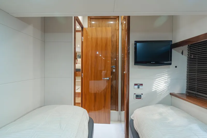 Slide: The Image of Cabin interior of 2010 Sunseeker Manhattan 60 yacht with twin beds and TV. - 17