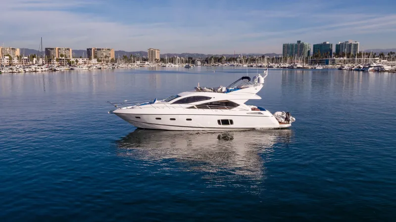Slide: The Image of 2010 Sunseeker Manhattan 60 yacht on calm water with cityscape background. - 5