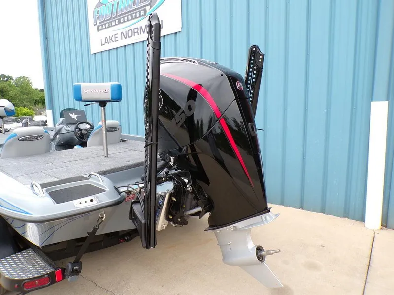 Slide: The Image of 2025 Phoenix 921 ELITE boat with powerful outboard motor, parked at a marina. - 18