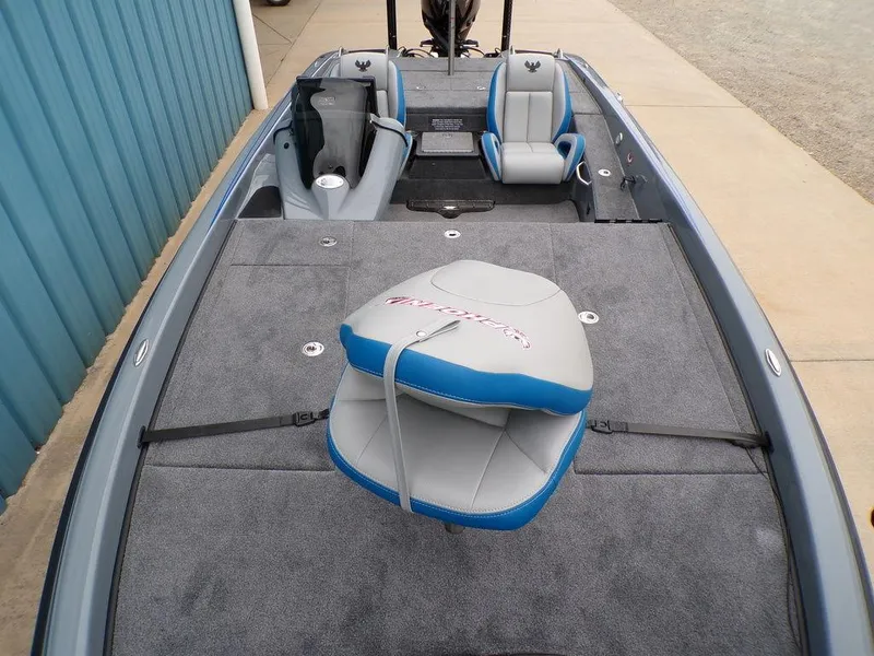 Slide: The Image of 2025 Phoenix 921 ELITE boat interior with gray and blue seating, spacious deck. - 8