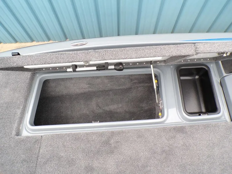 Slide: The Image of Open storage compartment in a 2025 Phoenix 921 ELITE boat. - 9