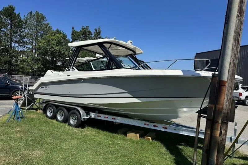 The Image of 2025 Boston Whaler 280 Vantage boat on trailer, parked outdoors on grass. - 0