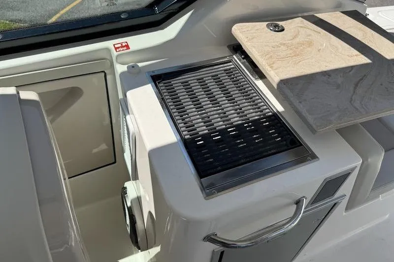 Slide: The Image of 2025 Boston Whaler 280 Vantage boat interior with grill and countertop. - 13