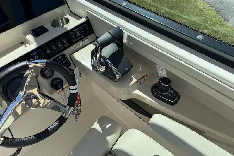 Slide: The Image of Interior view of 2025 Boston Whaler 280 Vantage boat cockpit with steering wheel and controls. - 6