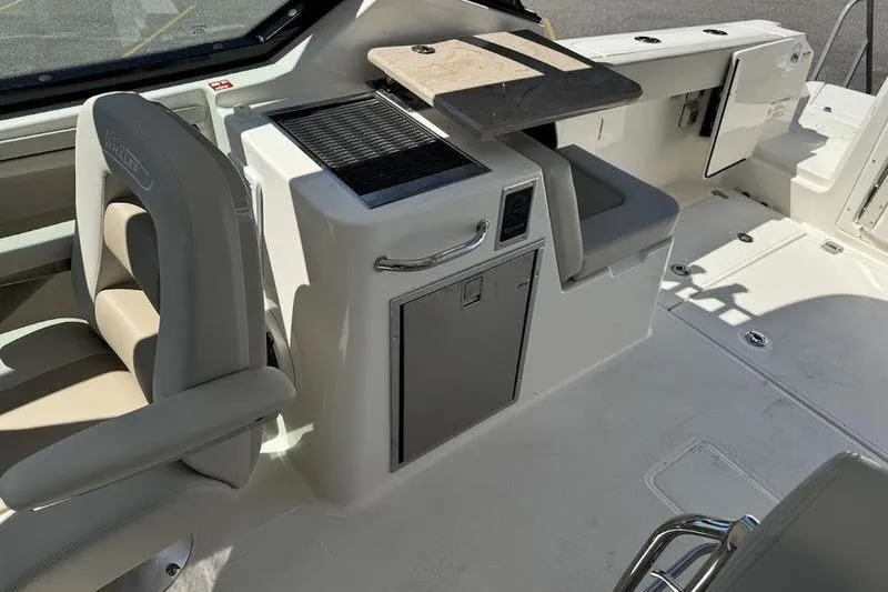 Slide: The Image of 2025 Boston Whaler 280 Vantage interior with seating and storage features. - 8