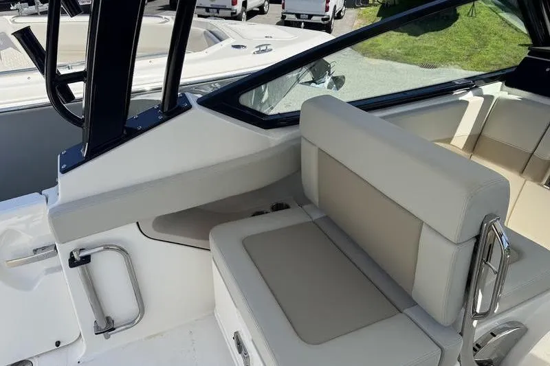 Slide: The Image of 2025 Boston Whaler 280 Vantage boat interior with cushioned seating and sleek design. - 9