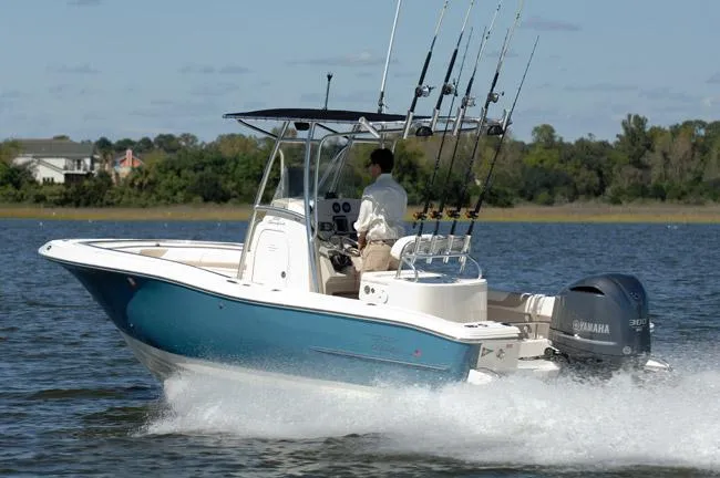 Slide: The Image of 2019 Pioneer 222 Sportfish boat cruising on water with fishing rods and Yamaha engine. - 10