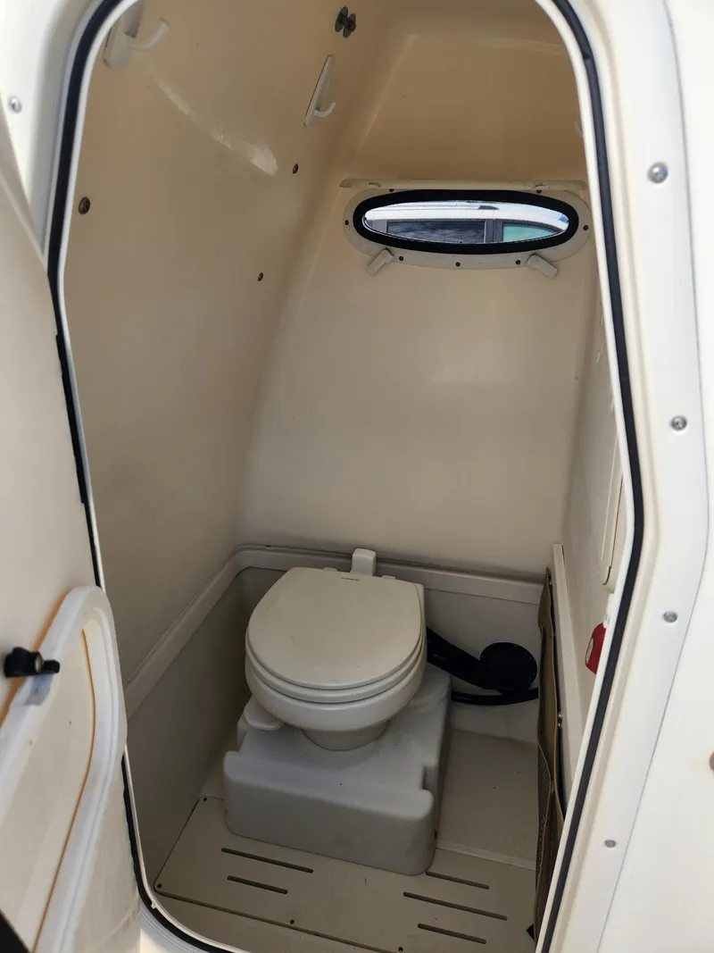 Slide: The Image of 2019 Pioneer 222 Sportfish boat interior with compact marine toilet. - 6