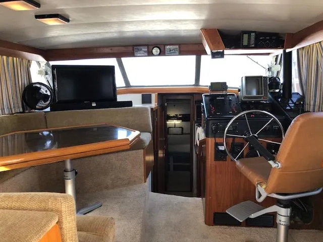Slide: The Image of 1988 Bayliner 3818 Motoryacht interior with helm, seating, and navigation equipment. - 10