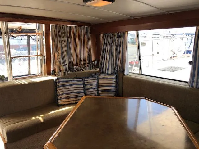 Slide: The Image of Interior of 1988 Bayliner 3818 Motoryacht with striped cushions and large windows. - 13