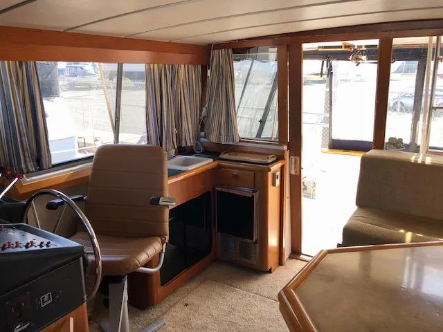 Slide: The Image of Interior of 1988 Bayliner 3818 Motoryacht with helm, seating, and windows. - 14