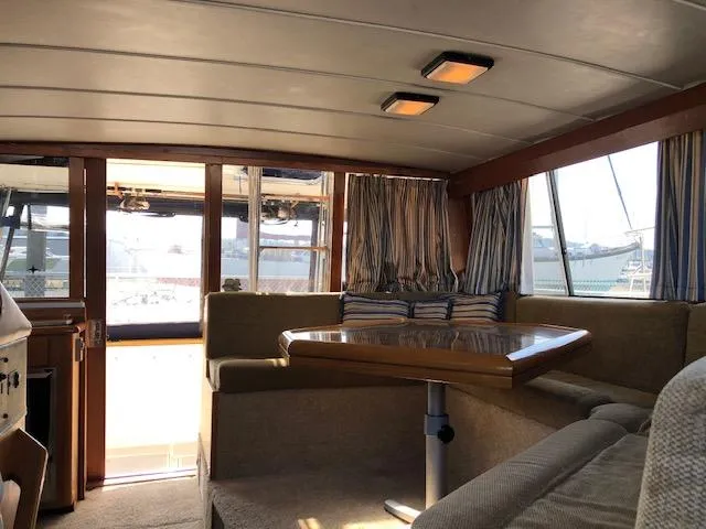 Slide: The Image of Interior of 1988 Bayliner 3818 Motoryacht with cozy seating and wooden table. - 15