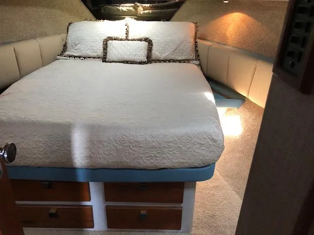 Slide: The Image of 1988 Bayliner 3818 Motoryacht bedroom with cozy bed and storage drawers. - 34