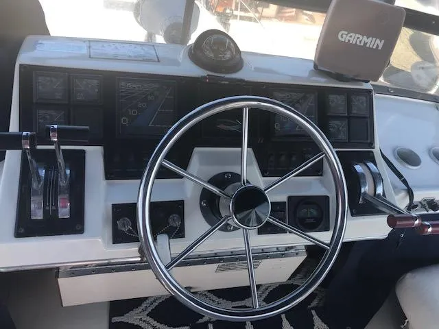 Slide: The Image of 1988 Bayliner 3818 Motoryacht helm with steering wheel and Garmin navigation system. - 4
