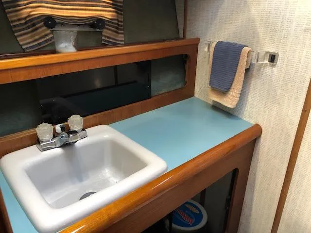 Slide: The Image of 1988 Bayliner 3818 Motoryacht bathroom with sink, mirror, and towel rack. - 40